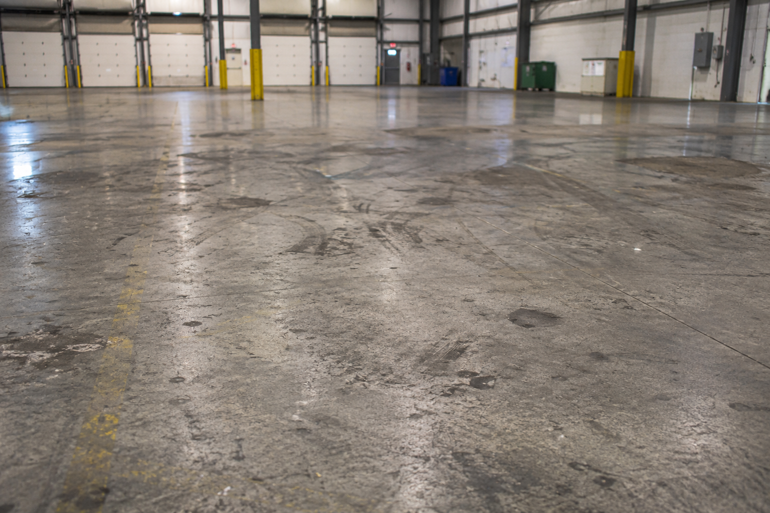 Warehouse concrete floor before commercial floor cleaning in Louisville KY